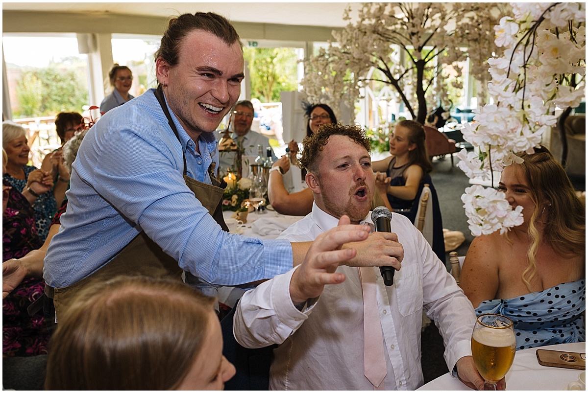 singing waiters entertain wedding guests at combermere abbey