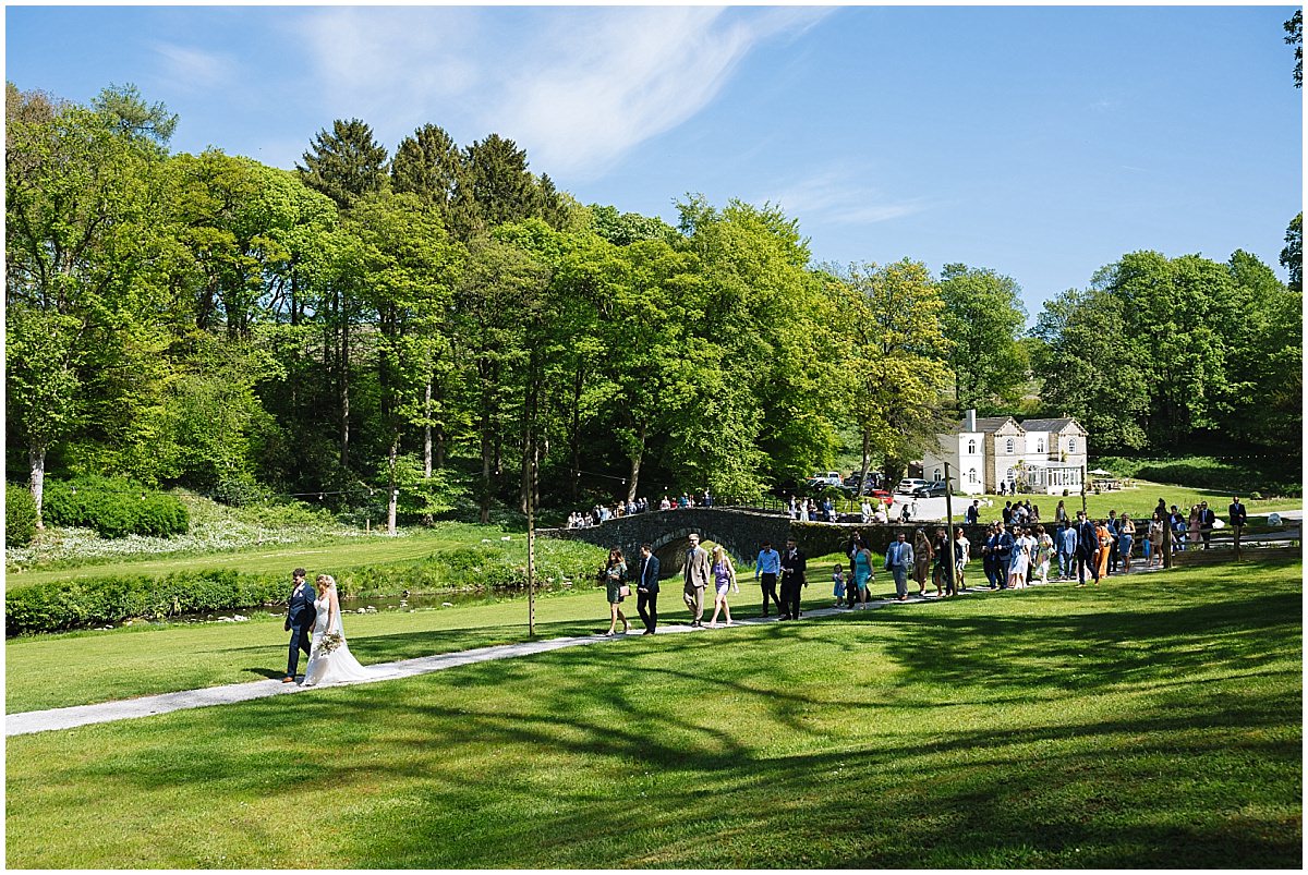 Bride and Groom walk their Guests to the wedding reception at Gisburne Park