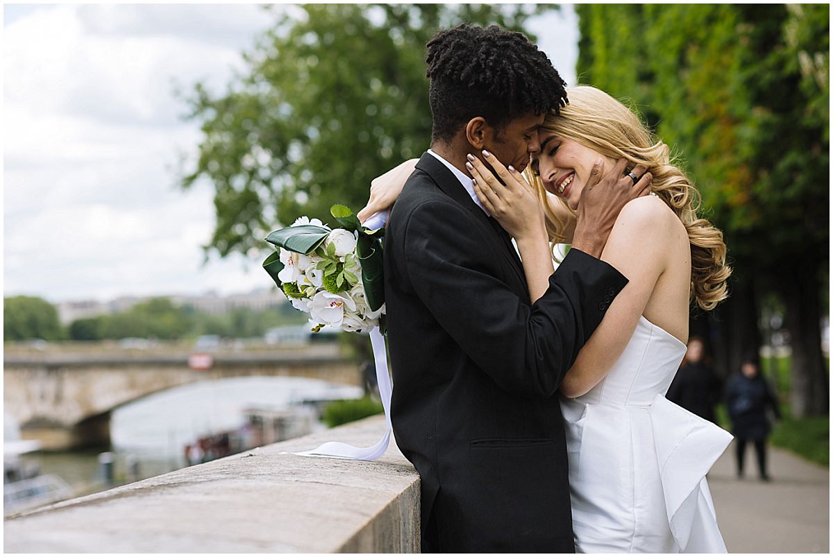 couple embrace on the pont alexander 3rd in paris
