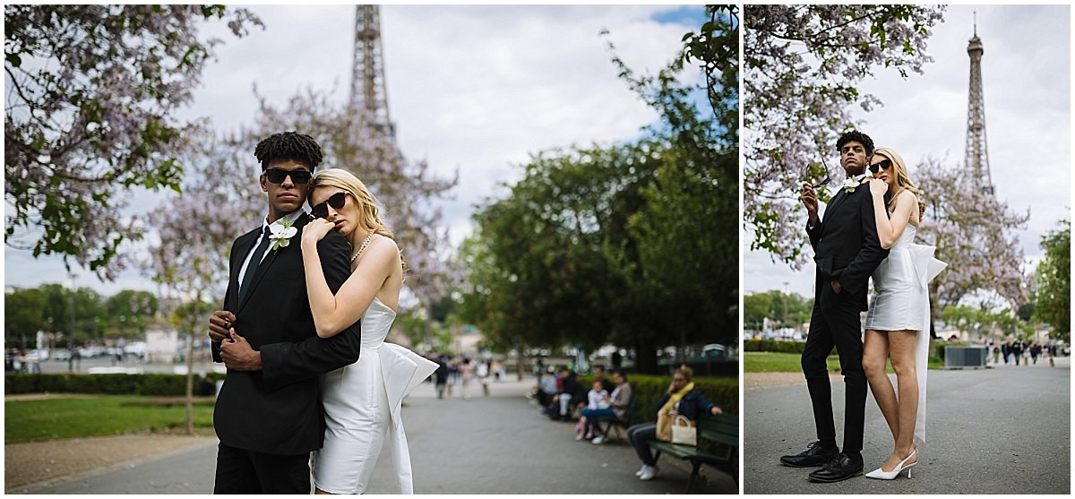 married couple pose under cherry blossoms near the eiffel tower in paris