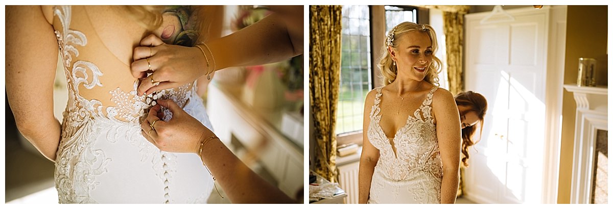 A bride getting dressed with the help of a friend, showcasing intricate lace details on the gown.