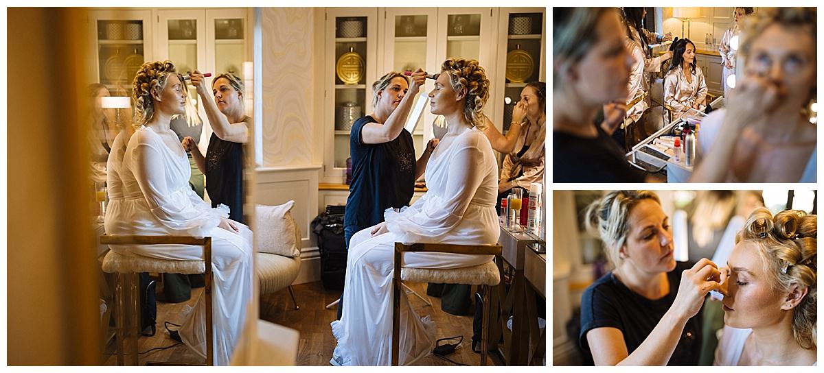 A scene capturing women getting ready for a black tie wedding at Colshaw Hall with makeup artists applying finishing touches in an elegant setting.