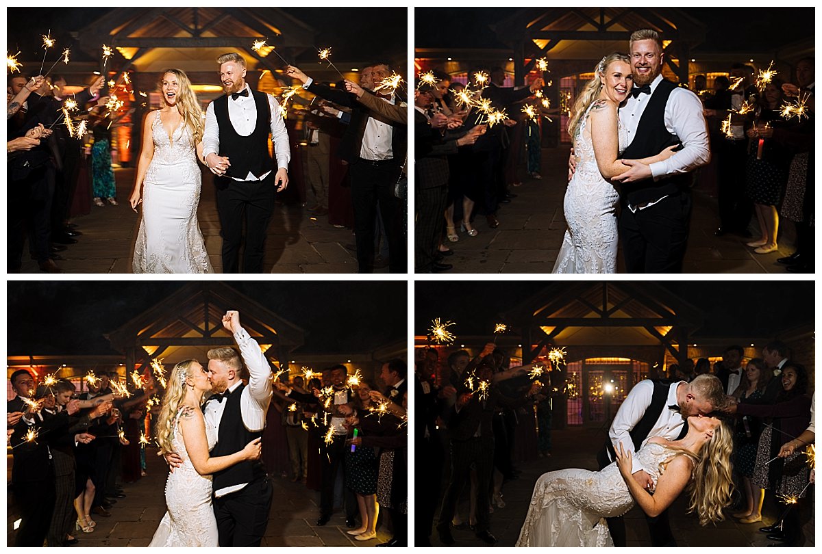A joyful couple celebrates their wedding surrounded by guests holding sparklers in a festive atmosphere.