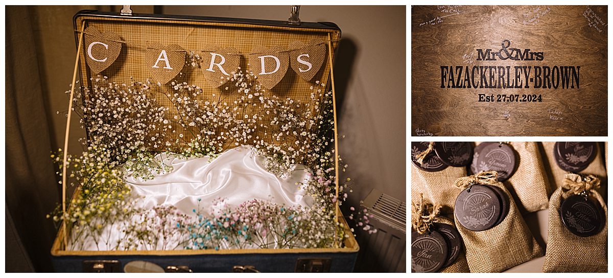 A beautifully arranged vintage suitcase filled with dried flowers and a "CARDS" sign, beside a wooden sign for Mr. & Mrs. Fazackerley-Brown, showcasing a rustic wedding theme.