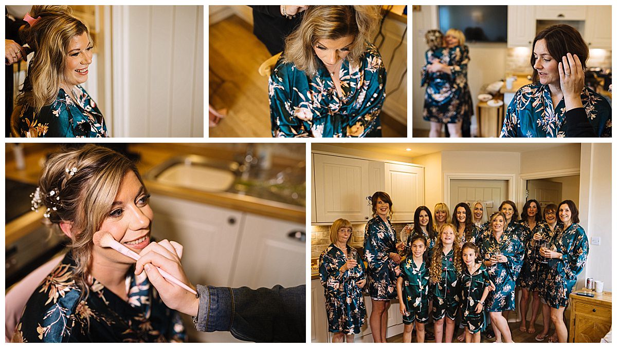 A joyful bridal party getting ready together, with women in floral robes, engaging in hair and makeup, and celebrating in a cozy kitchen setting.