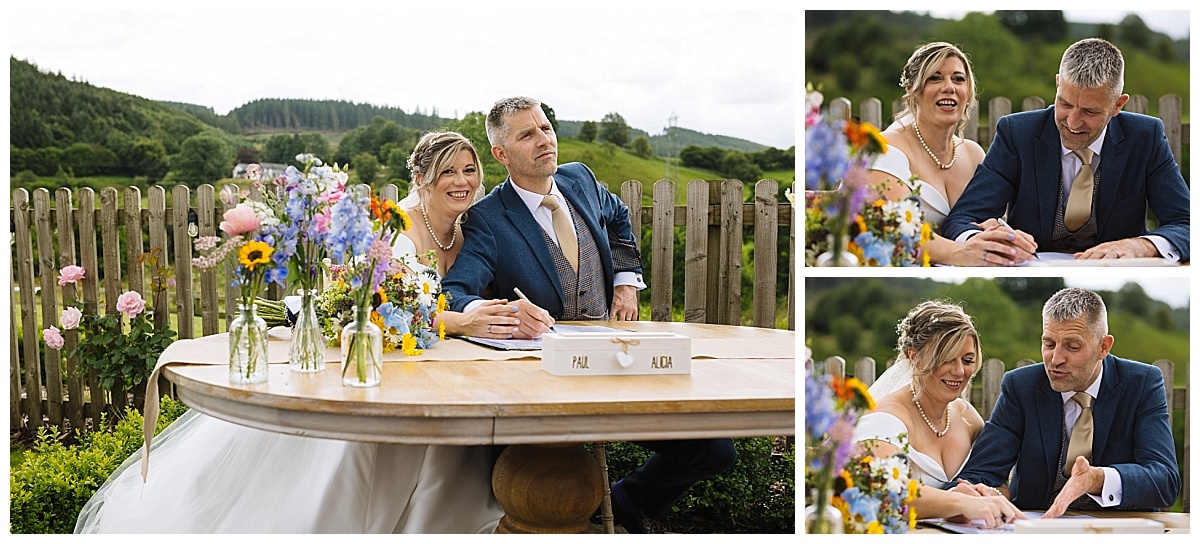 A couple engaged in a joyful moment during their wedding ceremony, surrounded by beautiful flowers and a scenic landscape.