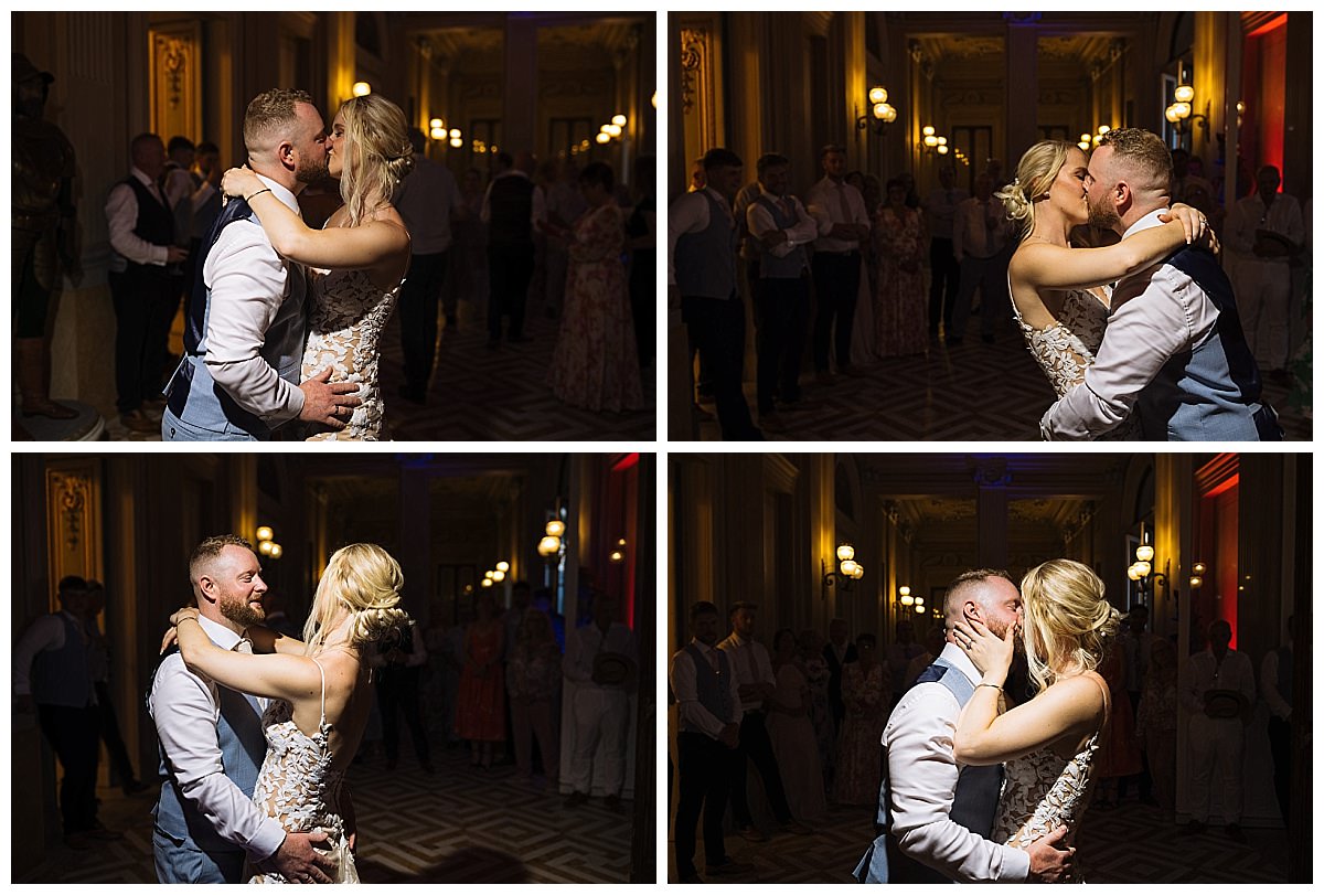 A couple shares intimate moments while dancing at their wedding, surrounded by guests in a beautifully lit entrance hall of Palazzo Parisio in Malta