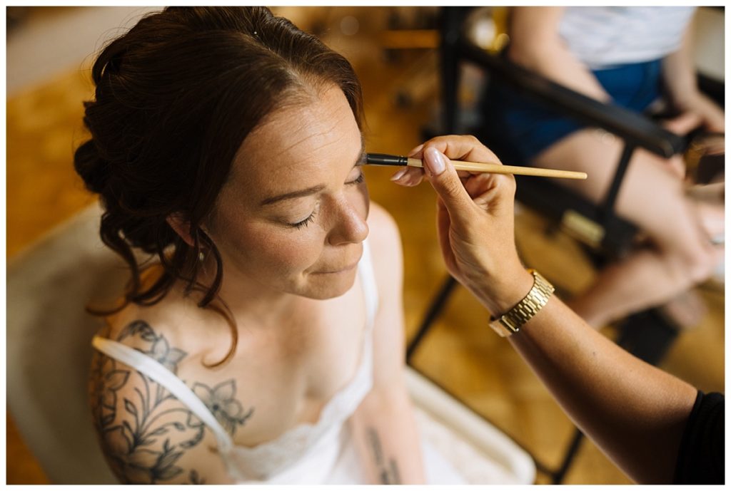 Bride having her makeup done on the morning of her Dalston Hall wedding